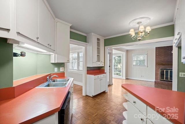 kitchen with black dishwasher, white cabinets, glass insert cabinets, ornamental molding, and a sink