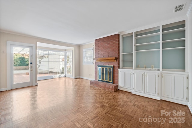 unfurnished living room featuring crown molding, visible vents, a fireplace, and baseboards