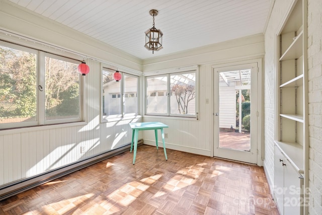 unfurnished sunroom with a baseboard heating unit