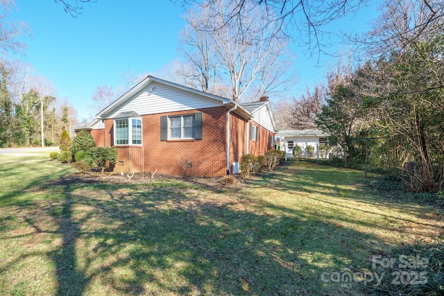 view of home's exterior with a yard, brick siding, and crawl space