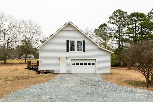 view of property exterior featuring a detached garage and crawl space