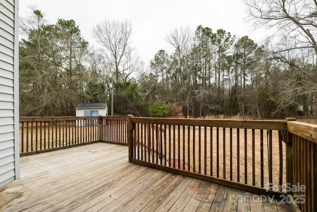 wooden deck with an outbuilding