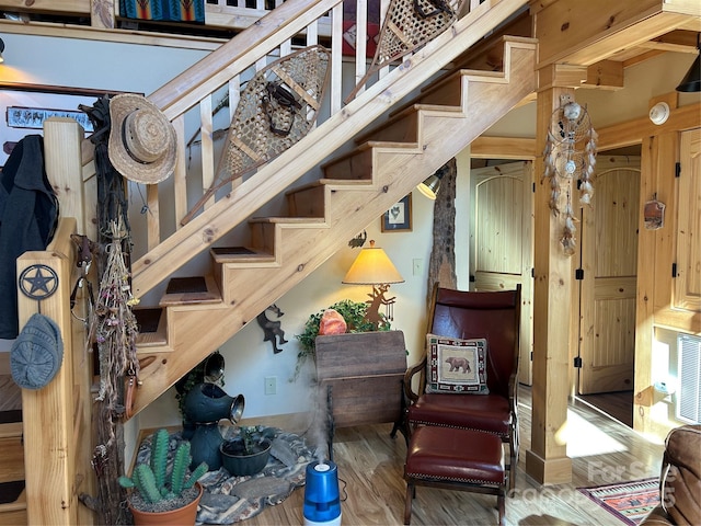 sitting room featuring stairway and wood finished floors