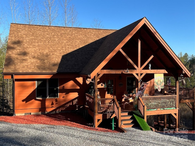 view of front of home featuring crawl space, a porch, and roof with shingles