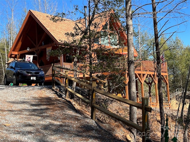 view of home's exterior with driveway and roof with shingles