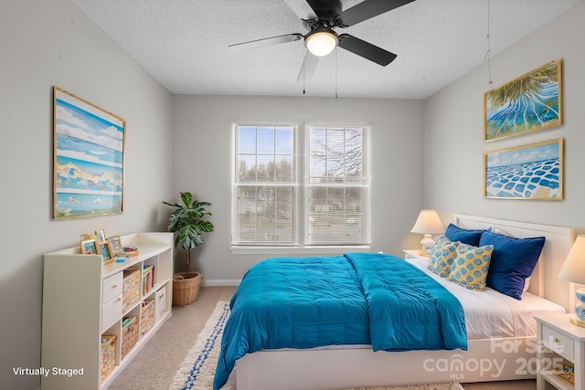 bedroom featuring a textured ceiling, carpet flooring, a ceiling fan, and baseboards