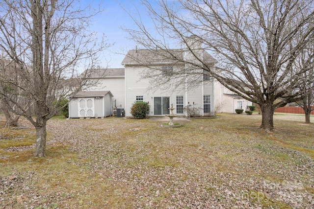 back of house featuring an outbuilding, a storage shed, and cooling unit