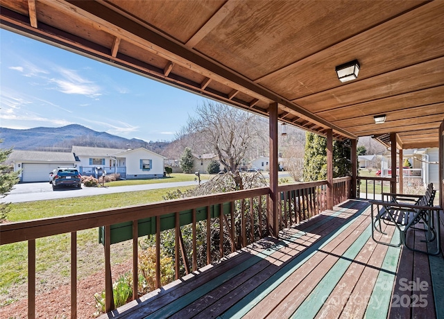 wooden deck with a residential view and a mountain view