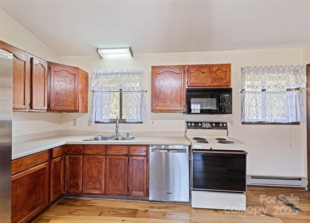 kitchen featuring electric stove, a baseboard radiator, stainless steel dishwasher, black microwave, and a sink