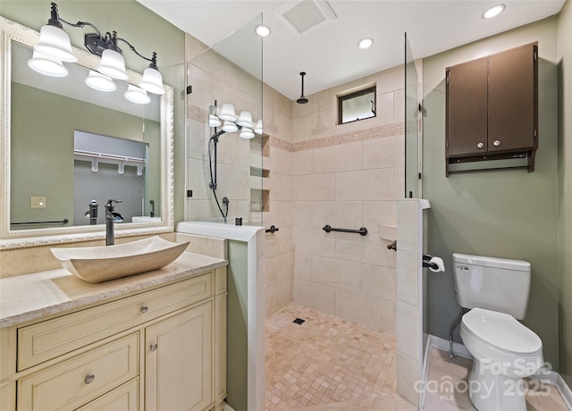 full bath with visible vents, toilet, walk in shower, vanity, and recessed lighting