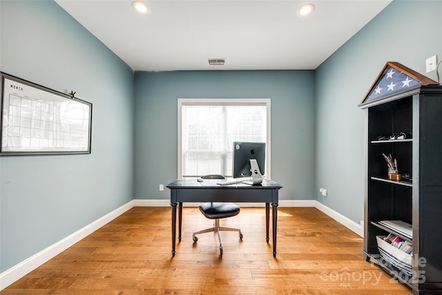 office space featuring light wood-type flooring, visible vents, baseboards, and recessed lighting