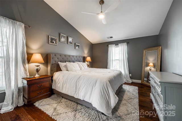 bedroom with baseboards, visible vents, ceiling fan, wood finished floors, and vaulted ceiling