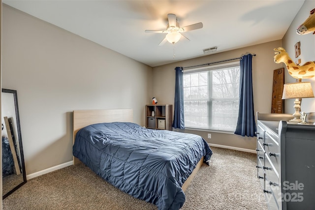 carpeted bedroom featuring baseboards, visible vents, and a ceiling fan