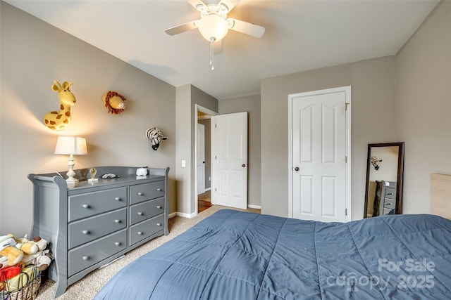 carpeted bedroom with ceiling fan and baseboards