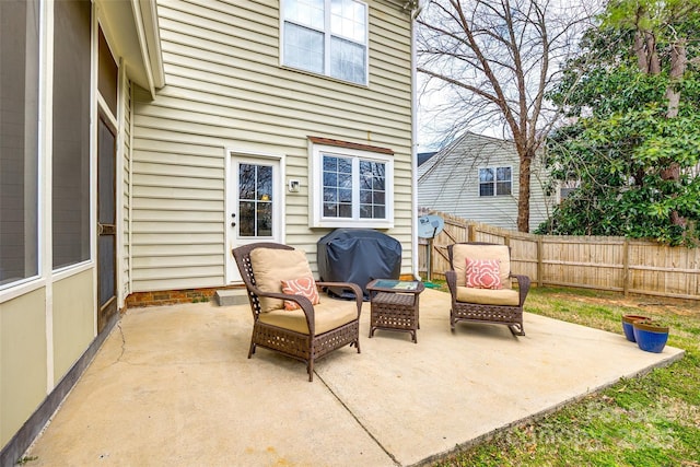 view of patio / terrace featuring a grill and fence