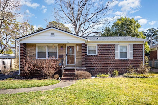 bungalow with roof with shingles, brick siding, crawl space, and a front yard