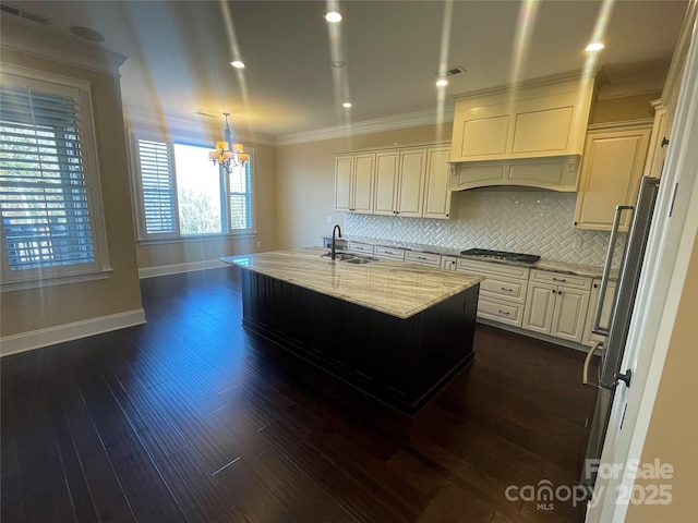 kitchen with stainless steel gas cooktop, dark wood-style flooring, light stone countertops, and crown molding