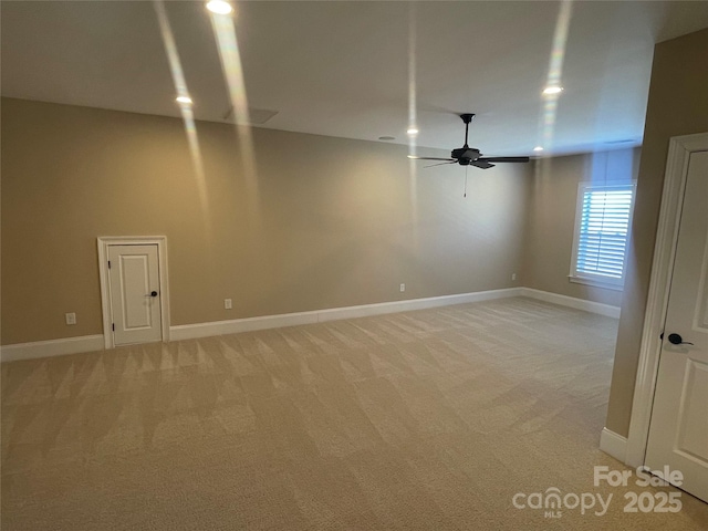 spare room with baseboards, recessed lighting, a ceiling fan, and light colored carpet