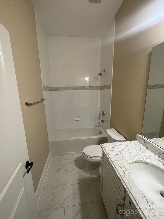 full bath with baseboards, toilet, marble finish floor, vanity, and washtub / shower combination