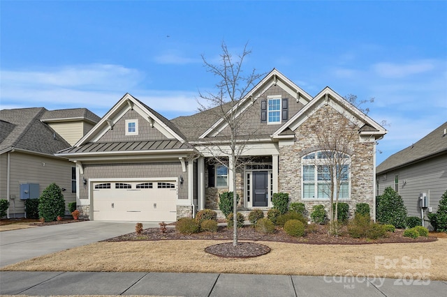 craftsman house with driveway, a standing seam roof, a garage, stone siding, and metal roof