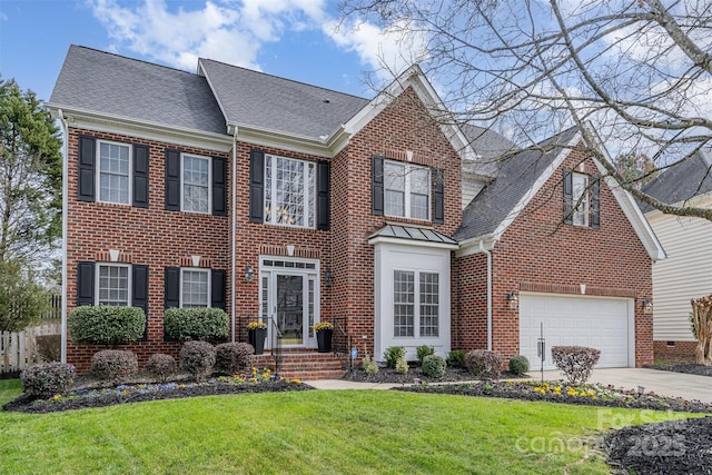 view of front of house with a shingled roof, a front yard, concrete driveway, and brick siding