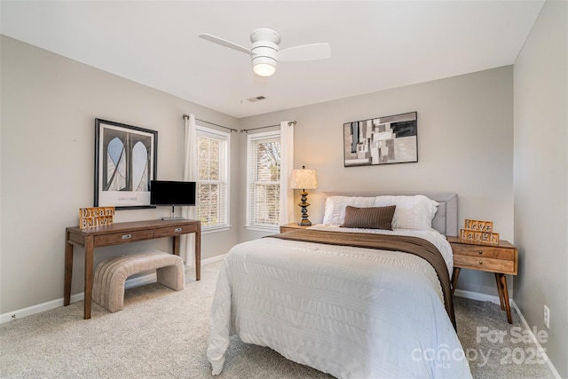 bedroom with carpet floors, visible vents, ceiling fan, and baseboards