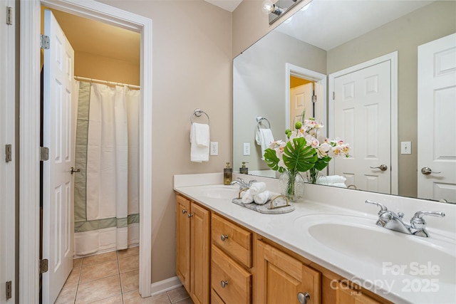 bathroom featuring double vanity, a shower with shower curtain, tile patterned flooring, and a sink