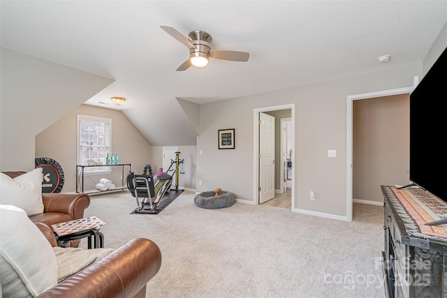 sitting room with a ceiling fan, lofted ceiling, light carpet, and baseboards