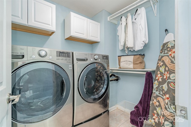 laundry room with washer and dryer, cabinet space, and light tile patterned floors