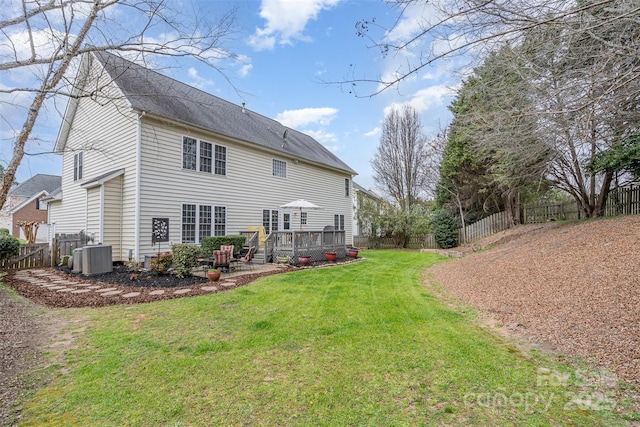 back of house with cooling unit, a fenced backyard, a yard, and a wooden deck