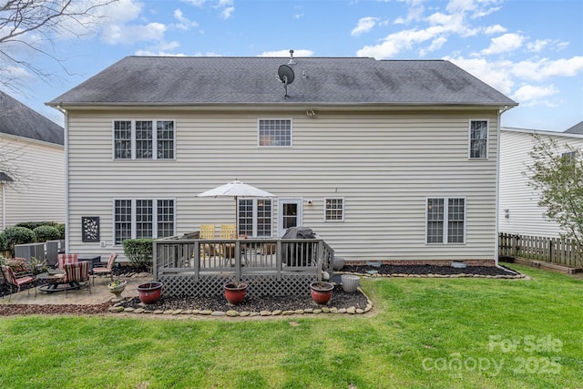 rear view of house featuring a yard, a patio area, fence, and a wooden deck