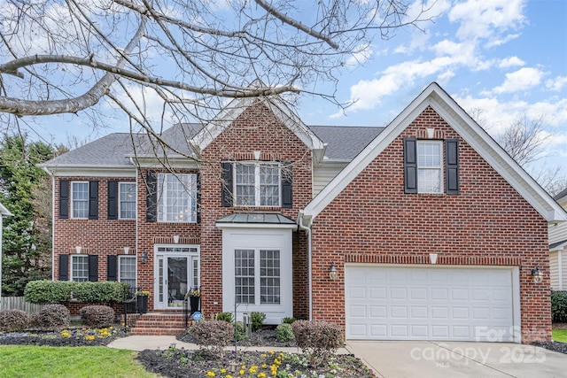 view of front of home with concrete driveway, brick siding, and roof with shingles