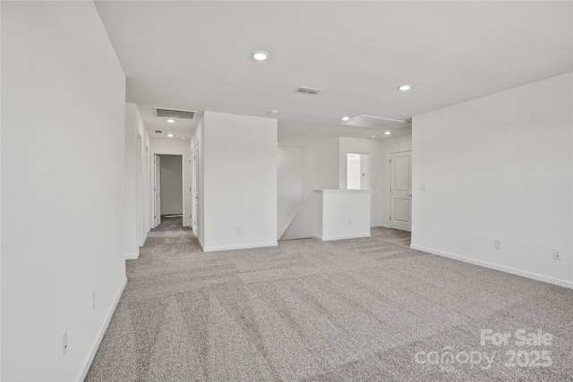 unfurnished room featuring light carpet, recessed lighting, visible vents, and baseboards