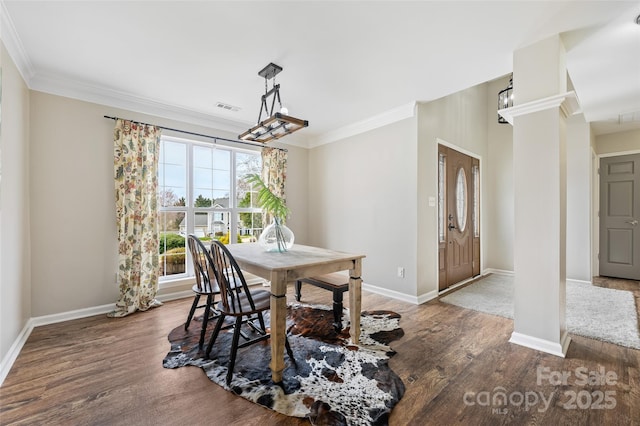 dining room with ornamental molding, wood finished floors, and visible vents