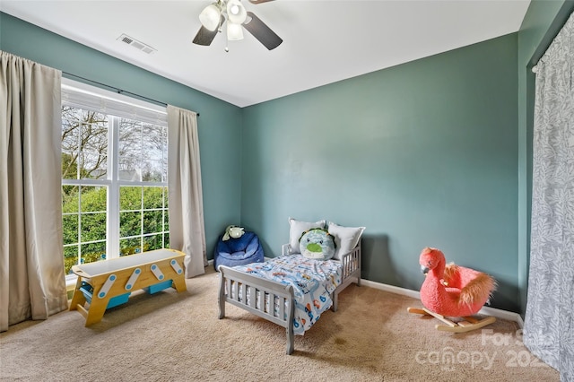 bedroom with carpet, visible vents, ceiling fan, and baseboards