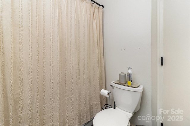 full bathroom with a shower with curtain and toilet