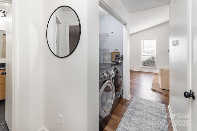 laundry area featuring laundry area, baseboards, washer and clothes dryer, and wood finished floors