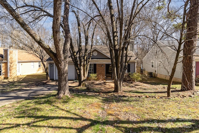 view of front facade featuring concrete driveway and brick siding