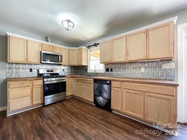 kitchen featuring light brown cabinetry, appliances with stainless steel finishes, a sink, and tasteful backsplash