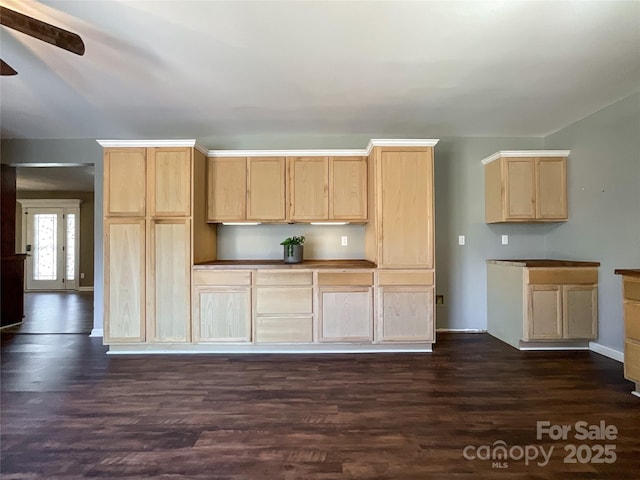 kitchen with dark wood-type flooring, ceiling fan, and light brown cabinetry