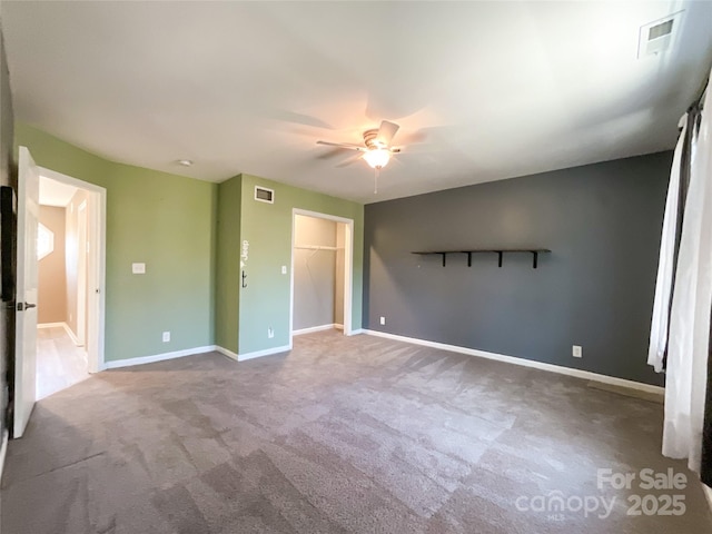 unfurnished bedroom featuring carpet, visible vents, and baseboards