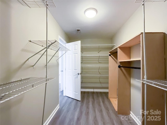 spacious closet with wood finished floors and visible vents