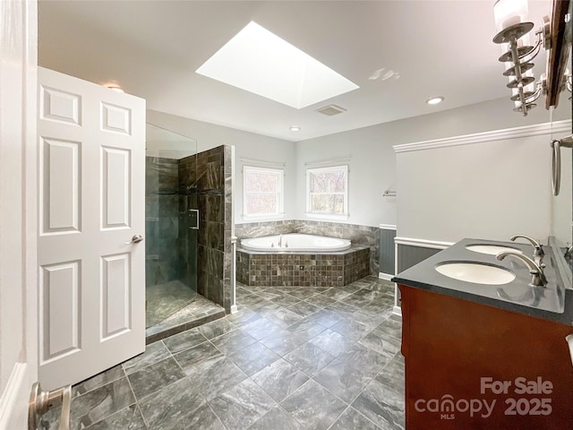 full bathroom with a skylight, a sink, a tile shower, a bath, and double vanity