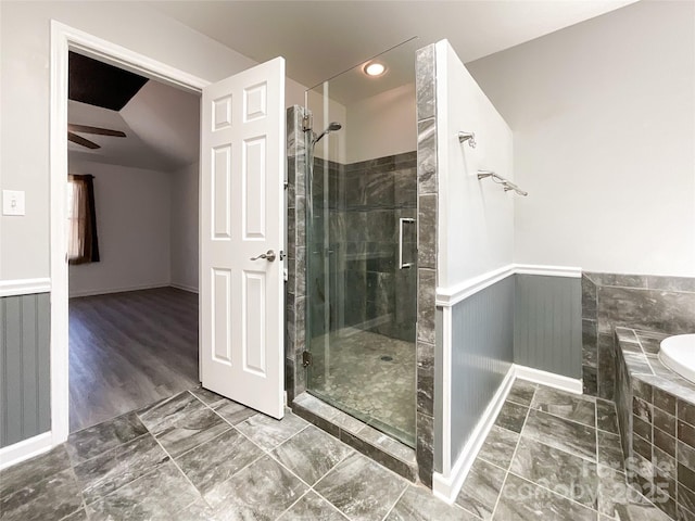 full bathroom with wainscoting, a garden tub, a ceiling fan, and a shower stall