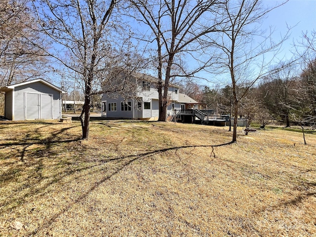 exterior space with a shed, a deck, and an outbuilding