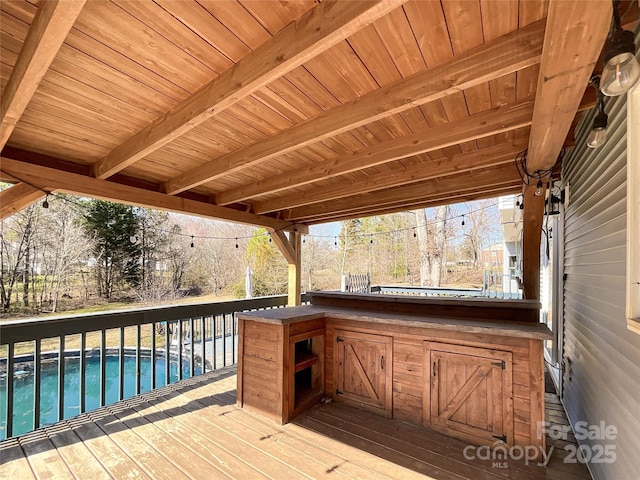 wooden terrace with an outdoor pool