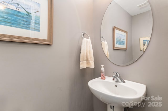 bathroom with visible vents and a sink