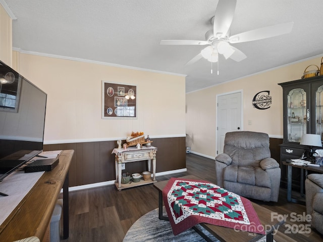 living area with dark wood-style floors, a textured ceiling, a ceiling fan, and crown molding