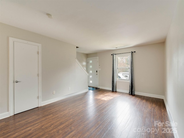 empty room with wood finished floors and baseboards