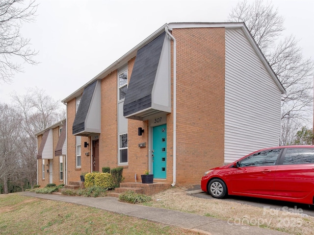 view of side of property with brick siding